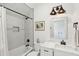 Bathroom featuring marble countertop, updated vanity and lighting, and tiled shower with black showerhead at 1809 Rushland Grove Ln, Johns Island, SC 29455