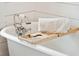 Close up of a claw foot bathtub with chrome fixtures and a wooden bath caddy at 1809 Rushland Grove Ln, Johns Island, SC 29455