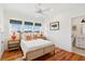 Bright bedroom featuring three large windows with views of the sky and hardwood flooring at 1809 Rushland Grove Ln, Johns Island, SC 29455