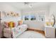 Comfortable bedroom featuring natural light from the windows, complemented by an off-white ceiling fan at 1809 Rushland Grove Ln, Johns Island, SC 29455