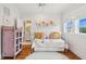 Comfortable bedroom featuring charming floral wallpaper, natural light from the windows, and hardwood flooring at 1809 Rushland Grove Ln, Johns Island, SC 29455