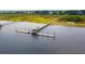 Aerial view of a private dock featuring a covered area and walkways through the marsh at 1809 Rushland Grove Ln, Johns Island, SC 29455