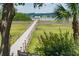 Picturesque view of a wooden walkway leading to a dock, nestled within lush marshland and vegetation at 1809 Rushland Grove Ln, Johns Island, SC 29455