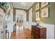 Inviting entryway with olive-painted walls, wood floors, and views into the living area at 1809 Rushland Grove Ln, Johns Island, SC 29455