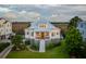 Stunning exterior elevation showcasing a raised beach house with a metal roof and meticulously manicured landscaping at 1809 Rushland Grove Ln, Johns Island, SC 29455