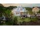 Beautiful elevated home featuring mature trees, an outdoor patio, and a metal roof at 1809 Rushland Grove Ln, Johns Island, SC 29455