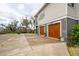 Beautiful home exterior with a long driveway leading to the garage and charming treehouse in the yard at 1809 Rushland Grove Ln, Johns Island, SC 29455