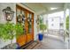 Welcoming entryway with double doors, hanging lanterns, and a cozy porch swing at 1809 Rushland Grove Ln, Johns Island, SC 29455