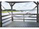 Relaxing view from a hammock overlooking the water, with a pier and boat visible in the distance at 1809 Rushland Grove Ln, Johns Island, SC 29455