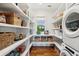 Walk-in pantry with ample shelving, providing plenty of storage space, plus washer and dryer at 1809 Rushland Grove Ln, Johns Island, SC 29455