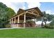 Outdoor pavilion with wooden architecture, columns, benches, and a view of the surrounding green space at 1809 Rushland Grove Ln, Johns Island, SC 29455