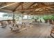 Spacious pavilion interior features picnic tables, rocking chairs, and open views of the water at 1809 Rushland Grove Ln, Johns Island, SC 29455
