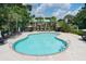 Large swimming pool surrounded by lounge chairs, umbrellas, and lush tropical landscaping for relaxation at 1809 Rushland Grove Ln, Johns Island, SC 29455