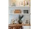 Close-up of a shelf displaying unique decor and mementos on built-in cabinetry at 1809 Rushland Grove Ln, Johns Island, SC 29455