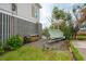 Exterior view of home with a boat on a trailer, set on a gravel area beside a grassy lawn at 1809 Rushland Grove Ln, Johns Island, SC 29455
