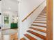 Bright staircase with wooden stairs and railing and white risers at 1809 Rushland Grove Ln, Johns Island, SC 29455
