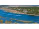 Stunning aerial view showcasing waterfront homes, marshland, and a speedboat cruising on the water at 1903 Bolden Dr, Mount Pleasant, SC 29466