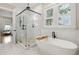 Bright bathroom featuring a soaking tub, glass shower, and large windows at 1903 Bolden Dr, Mount Pleasant, SC 29466
