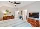 Comfortable bedroom features dresser, television, ceiling fan and ensuite bathroom at 1903 Bolden Dr, Mount Pleasant, SC 29466