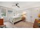 Comfortable bedroom features a ceiling fan, bedside table with lamp, and double door closet at 1903 Bolden Dr, Mount Pleasant, SC 29466