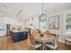 Open-concept kitchen and dining area with a large island and a round wooden table at 1903 Bolden Dr, Mount Pleasant, SC 29466