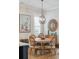 Well-lit dining area with a round table, rattan chairs, and coastal-themed artwork at 1903 Bolden Dr, Mount Pleasant, SC 29466