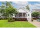 Charming home features a well-manicured lawn and inviting screened in porch at 1903 Bolden Dr, Mount Pleasant, SC 29466