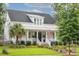 Charming two-story home with a welcoming front porch, manicured lawn and beautiful landscaping at 1903 Bolden Dr, Mount Pleasant, SC 29466