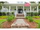 Inviting front entrance with a brick and stone walkway leading to a covered porch and stylish black double doors at 1903 Bolden Dr, Mount Pleasant, SC 29466