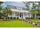 Charming home with a welcoming front porch, American flag, and lush landscaping at 1903 Bolden Dr, Mount Pleasant, SC 29466