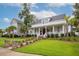 Charming home featuring a welcoming porch, manicured lawn, and lush landscaping at 1903 Bolden Dr, Mount Pleasant, SC 29466