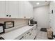 Laundry room features custom cabinets, counterspace, sink, and modern appliances at 1903 Bolden Dr, Mount Pleasant, SC 29466