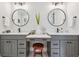 Bright, elegant bathroom featuring double vanities, quartz countertops, and modern light fixtures at 1903 Bolden Dr, Mount Pleasant, SC 29466