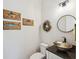 Stylish powder room featuring unique fish artwork, decorative wreath, and a vessel sink at 1903 Bolden Dr, Mount Pleasant, SC 29466