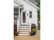 Back entrance of home with stairs, a grill, and landscaped flower pots at 1903 Bolden Dr, Mount Pleasant, SC 29466