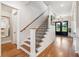A beautiful stairway leading up to the second floor with natural light and views of the lake at 1903 Bolden Dr, Mount Pleasant, SC 29466