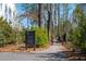 Landscaped walking path in a community featuring lush vegetation and neighborhood signage at 1903 Bolden Dr, Mount Pleasant, SC 29466