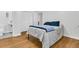 Bedroom boasting hardwood floors and neutral walls, with a full ensuite bathroom at 1909 Swift Ave, Charleston, SC 29407