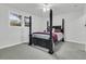 Spacious bedroom with a four-poster bed, plush carpeting, and sun-filled windows at 1909 Swift Ave, Charleston, SC 29407