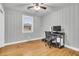 Bedroom with neutral walls, hardwood floors, a ceiling fan, and a window providing natural light at 1909 Swift Ave, Charleston, SC 29407