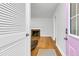 Bright entryway leading to a living area with hardwood floors and a cozy fireplace at 1909 Swift Ave, Charleston, SC 29407
