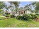 Charming single-story home with mature landscaping and a well-kept lawn at 1909 Swift Ave, Charleston, SC 29407
