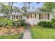 Charming single-story home with a lush front yard and a welcoming pink front door at 1909 Swift Ave, Charleston, SC 29407