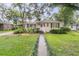 Inviting single-story home with a well-manicured lawn and a quaint front walkway at 1909 Swift Ave, Charleston, SC 29407