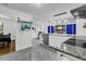 Open concept kitchen with white cabinets, granite countertops, stainless steel appliances, and stylish tile flooring at 1909 Swift Ave, Charleston, SC 29407