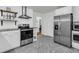 Modern kitchen featuring stainless steel appliances, white cabinets, and stylish backsplash at 1909 Swift Ave, Charleston, SC 29407