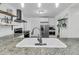 Bright kitchen showcasing a stainless steel refrigerator, modern appliances, granite countertops, and a white ceramic sink at 1909 Swift Ave, Charleston, SC 29407