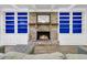 Beautiful living room showcasing a brick fireplace, built-in blue bookshelves, and hardwood floors at 1909 Swift Ave, Charleston, SC 29407