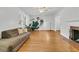Sun-lit living room with hardwood floors, large windows, a ceiling fan and a fireplace at 1909 Swift Ave, Charleston, SC 29407