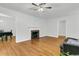 Inviting living room featuring hardwood floors, a fireplace, and views of the adjacent dining area at 1909 Swift Ave, Charleston, SC 29407
